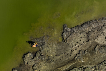 A fisherman fishing in the lake