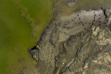 A fisherman fishing in the lake