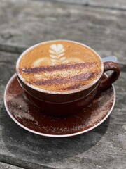 A cup of coffee on the wooden table 