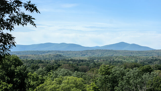 beautiful view of slide mountain in the catskill mountains of upstate new york (hudson valley mountain vista with natural frame from tree leaves) blue hills summer lush greenery nature hiking camping