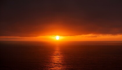 A big sun rises under the dark sky