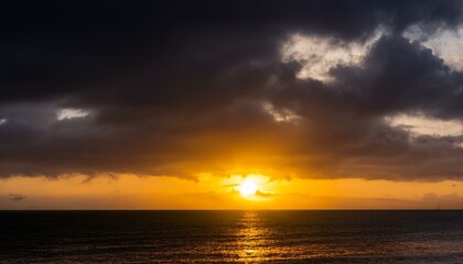 A big sun rises under the dark sky