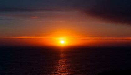 A big sun rises under the dark sky