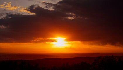 A big sun rises under the dark sky