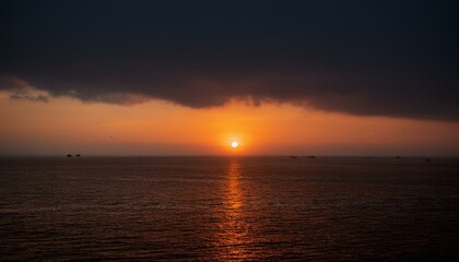 Fototapeta premium A big sun rises under the dark sky