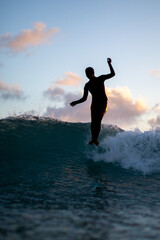 Woman Riding Waikiki Waves at Dusk