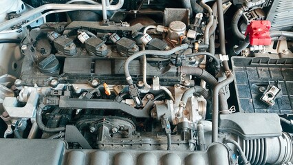 Fototapeta premium Detailed View of Engine Components in a Car's Engine Compartment