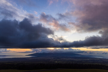 Landscape view of the sunset on the island of Maui as seen from the side of Haleakala in Hawaii.