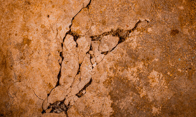 Cracked Brown wall texture. Dirty Grunge Stone background. Sandy Rough structure. Abstract texture. Rock surface with cracks. Urban design. Focus on wall. noisy, similar others