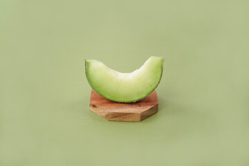 Green cantaloupe melon with cut slice isolated on white background, green melon