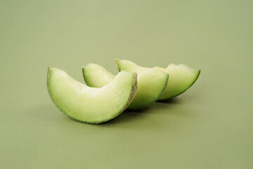 Green cantaloupe melon with cut slice isolated on white background, green melon