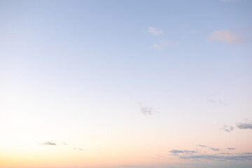 A calm twilight sky features gentle pastel shades blending into one another, creating a peaceful ambiance above the horizon. The scene evokes a sense of tranquility and beauty.