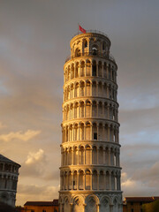 Tower of Pisa, Torre di Pisa, the sun is shining on the tower during golden hour on a warm sunny summers day. High quality image. The sun is setting in Tuscany