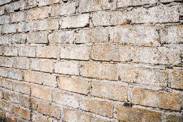 Brown white house brick wall surface texture background weathered bricks, cement joints, and old aged, grungy appearance. Ideal for urban, vintage design. Focus on wall, noisy, similar others