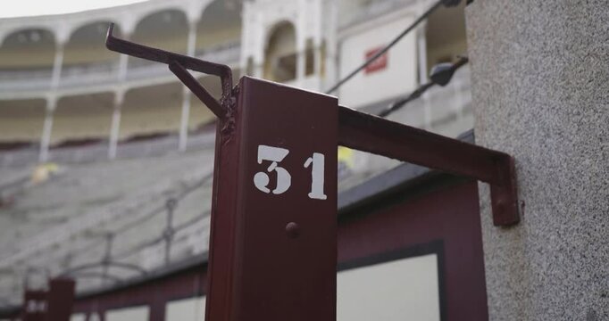 Beautiful slow motion zoom shot of the number 31 grandstand area of ​​the Las Ventas bullring in Madrid during the day.