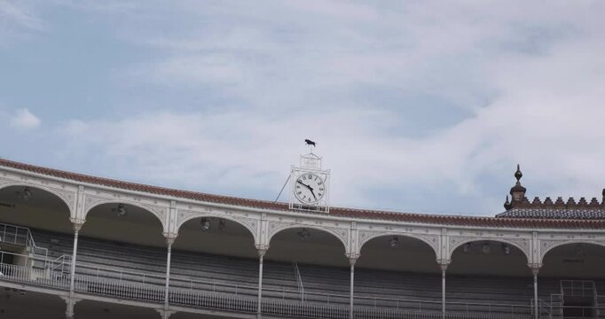 Beautiful slow motion zoom in shot of a large antique clock located at the top of the Las Ventas bullring in Madrid, Spain.
