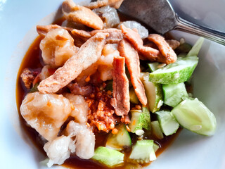 Siomay with delicious peanut sauce and cucumber topping