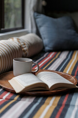 Reading a book with a cup of tea
