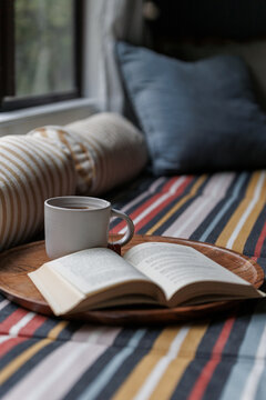 Reading a book with a cup of tea