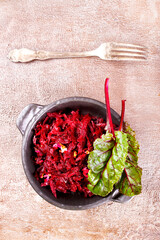 Beetroot salad with wallnuts and garlic in bowl