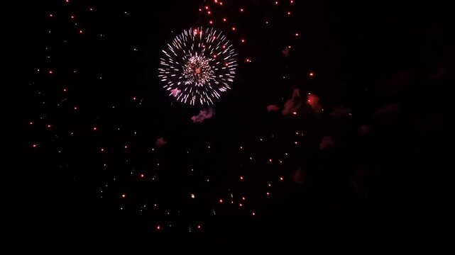 4K colorful fireworks in the night sky. Colorful pyrotechnic show right above your head. Magic and fairy tale on new year's eve. Festival, wedding, Happy Birthday, Christmas, Diwali, New year