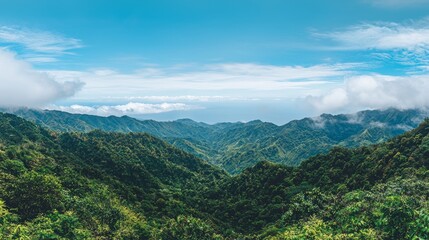 Lush green mountains under a bright blue sky with clouds.