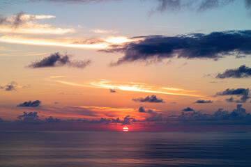 breathtaking sky at sunset or sunrise, with light clouds drifting across and the real sun casting a warm glow