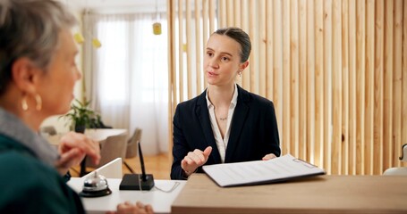 Obraz premium People, client and receptionist in hotel with clipboard, booking information and checklist on counter. Help desk, hospitality and concierge with mature customer for service, assistance or reservation