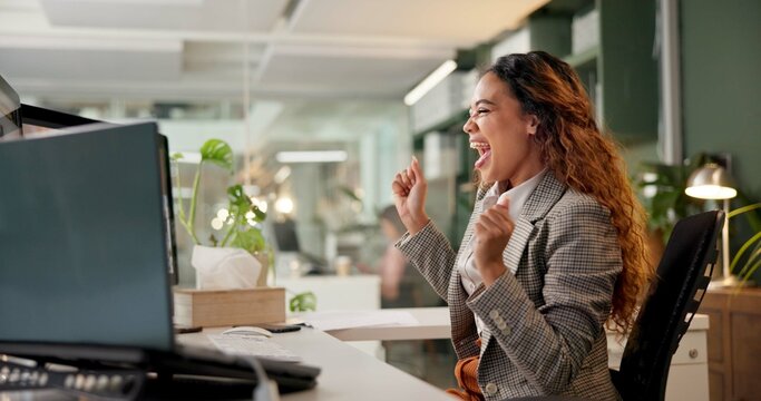 Woman, excited and celebration by computer in office, night and happy for goals, success and bonus at company. Person, cheers and smile for promotion, performance or achievement at creative agency