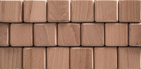 A series of wooden blocks are meticulously aligned to form a uniform, rectangular pattern creating...