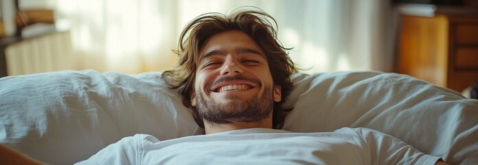 A cheerful individual lying down in a flat, laughing at a funny movie scene