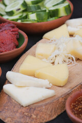 A delightful variety of Fresh Cheeses and Accompaniments beautifully presented on a Wooden Board