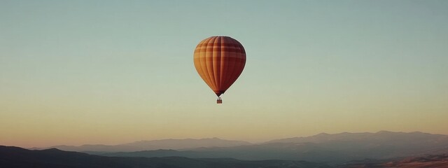 Lone Hot Air Balloon Gliding Through a Bright Blue Sky, Captivating Serenity and Freedom in the Air