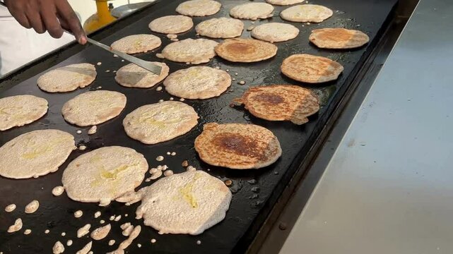 Making ragi dosas on the pan by a chef