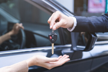 Business car rental, sell or buy service, dealership agent dealer sale hand giving auto key of...