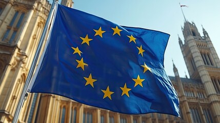 A European Union flag waves in front of the parliament on a sunny day, celebrating Europe’s progress and unity.