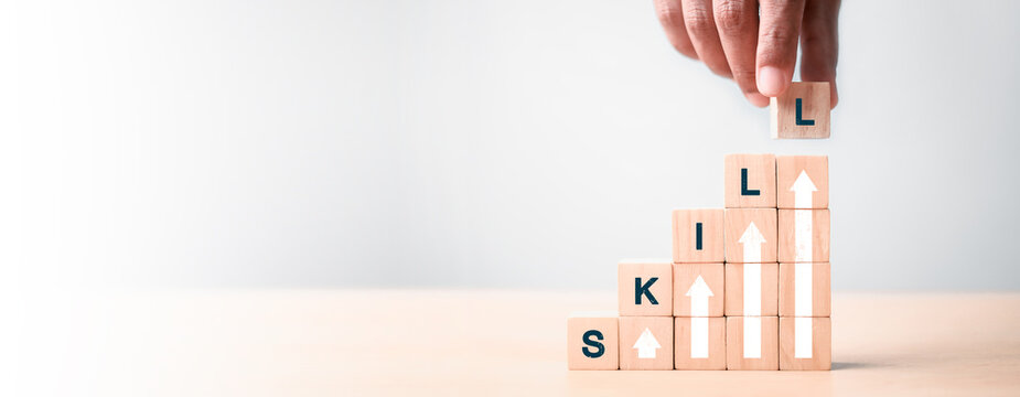 skills icon on wooden cube. Upskilling and personal development concept. Skill training, education, learning, ability. Upskilling, reskilling,