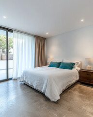 Modern minimalist bedroom with a large window and natural light in a tranquil setting
