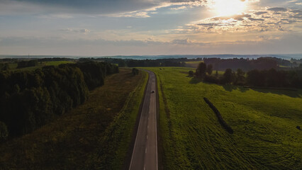dawn over the road on which the car is traveling