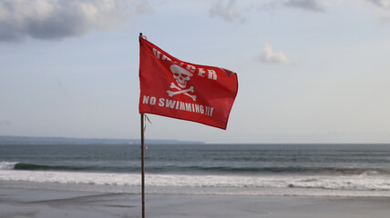Danger No Swimming warning sign Red Flag on the Indian Ocean Beach 