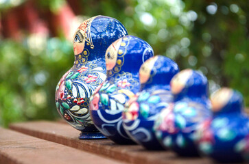 pair russian nesting dolls sit on table in front of green background