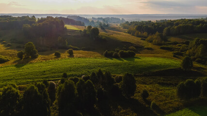 dawn over a green hilly meadow