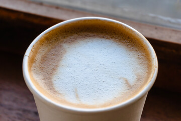 Close Up of Paper cup Coffee take-away, High Angle View. Wooden table and place for text.table and place for text.