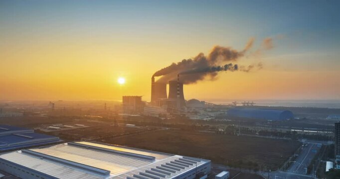 surround aerial time lapse video of the thermal power plant  in sunrise, traditional fossil energy industry landscape