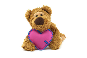 Adorable teddy bear holding a pink heart with blue stitching, expressing love and warmth on a white