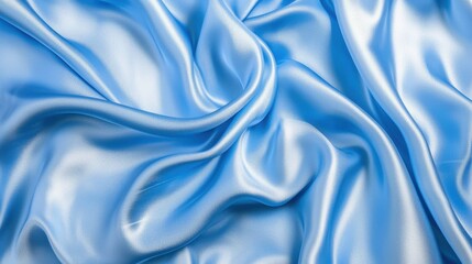Fototapeta premium A close-up view of smooth, flowing blue satin fabric, showcasing its sheen and texture. Perfect for design and textile applications.