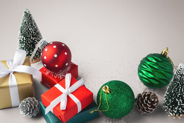 Christmas background, gift boxes with christmas balls and decor on beige background