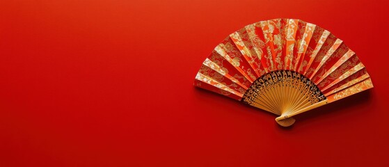 A red background with a red and gold fan