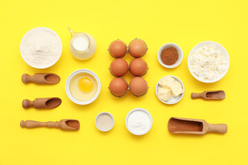 Different ingredients for preparing sweet cinnamon roll on yellow background