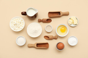 Different ingredients for preparing sweet cinnamon roll on beige background